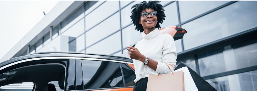 Woman next to car